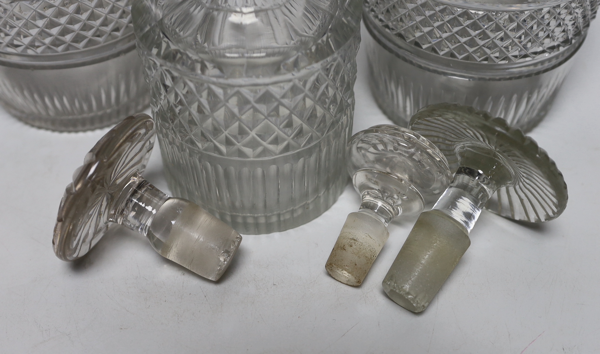 Three Georgian/Regency cut glass decanters, including a liqueur decanter, all with flattened stoppers, highest 25cm (3)